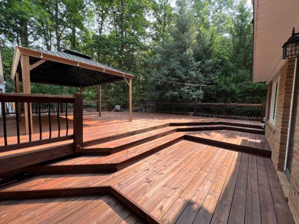 Preserved outdoor entertaining space with stained deck and exterior wood surfaces.