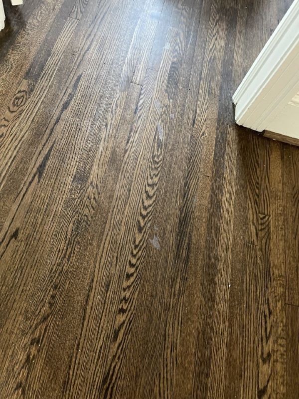 Picture showing where improper painting prep ruined hardwood floor