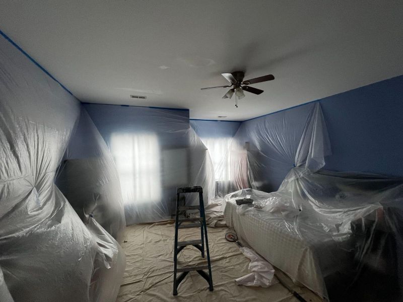 High-quality interior ceiling repair with minimal disruption by DeHaan Painting, room protected with plastic coverings