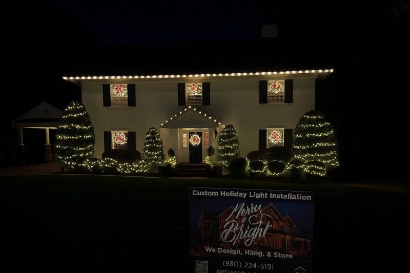 Charlotte home after professional holiday light installation by DeHaan Painting — crisp roofline, glowing wreath, and perfectly balanced LED lighting design that transforms the home into a neighborhood showpiece.