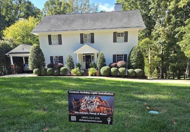 Charlotte home before professional holiday light installation by DeHaan Painting — dark roofline, uneven strands, and minimal lighting before transformation.