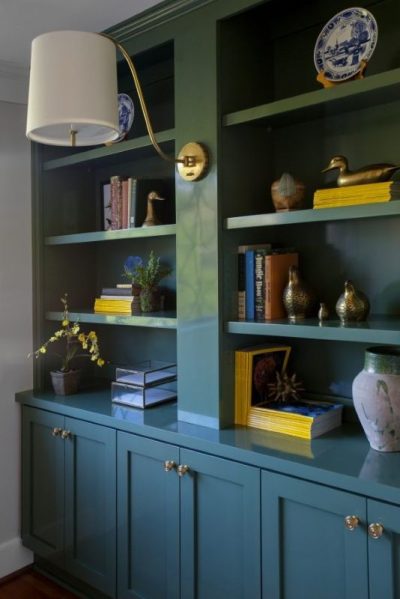 Blue bookcase used as a bold accent in a modern room, highlighting a 2026 color trend