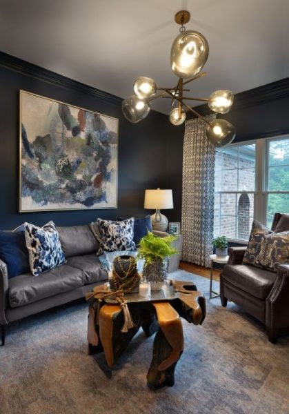 Living room featuring layered contrast with warm neutral walls, deeper-toned cabinetry or built-ins, and darker trim accents