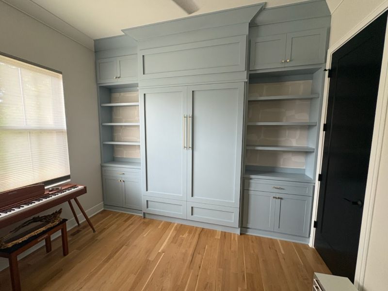 Professionally Painted Kitchen Cabinets with Built-In Storage Freshly painted light blue kitchen cabinets with built-in shelving showcasing a modern cabinet refresh