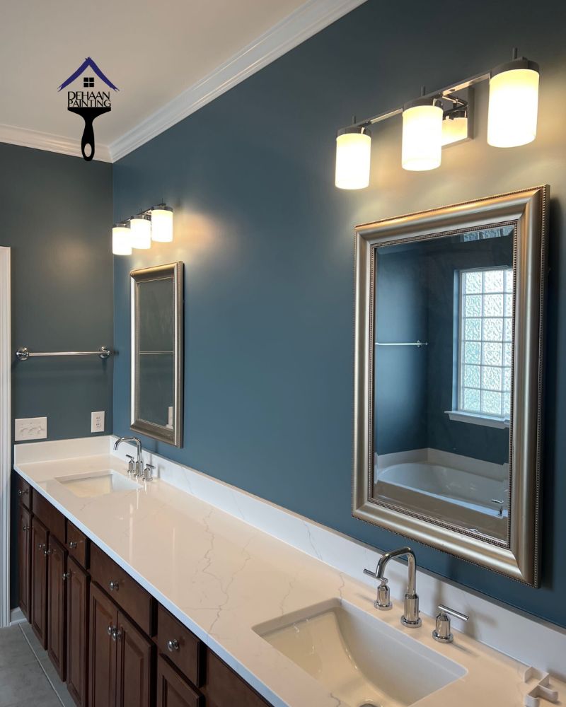 Why Professional Prep Matters | Bathroom Painting and Prep Work Quality Freshly painted bathroom with deep blue walls, white vanity countertop, and framed mirrors showing the clean finish achieved through professional prep work